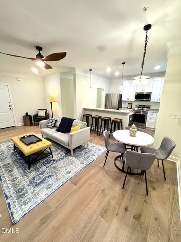 a living room with furniture a rug and a chandelier