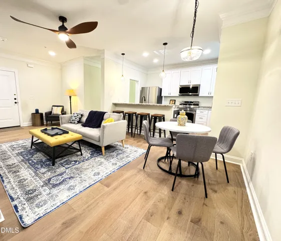 a living room with lots of furniture and kitchen view