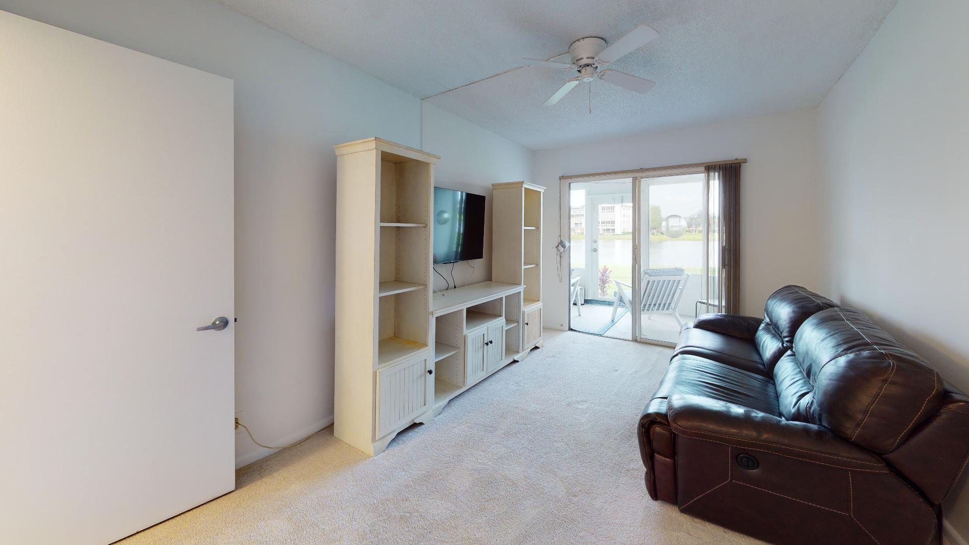 1014 Exeter Boca Raton, FL 33434 - Photo 17 of 31 a living room with furniture and a flat screen tv