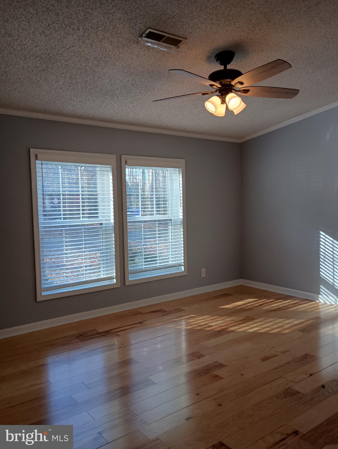 32217 Sandpiper Drive Lewes, DE 19958 - Photo 11 of 21 a view of an empty room with wooden floor and a window