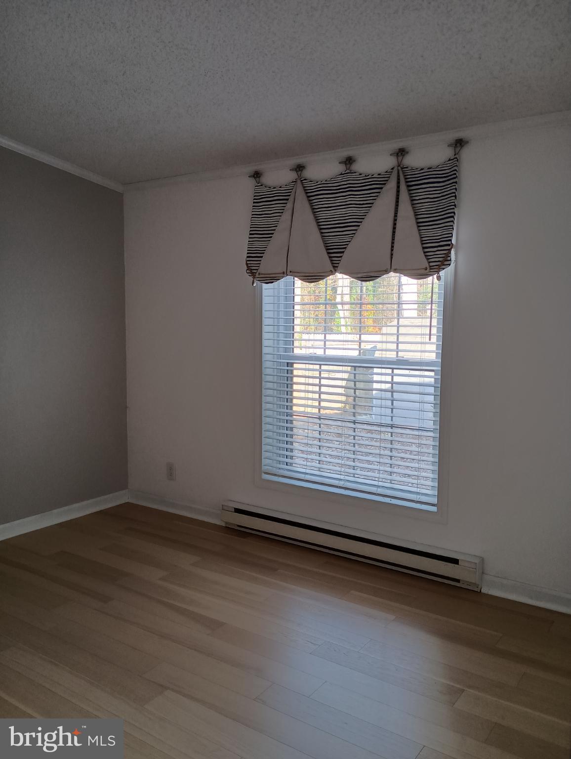 32217 Sandpiper Drive Lewes, DE 19958 - Photo 14 of 21 an empty room with wooden floor and windows