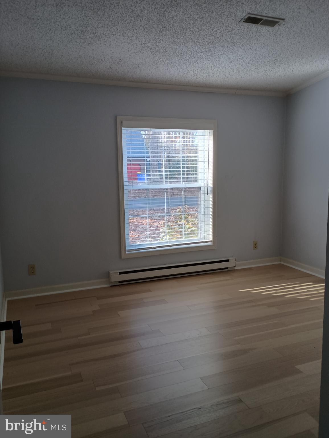 32217 Sandpiper Drive Lewes, DE 19958 - Photo 15 of 21 an empty room with wooden floor and windows