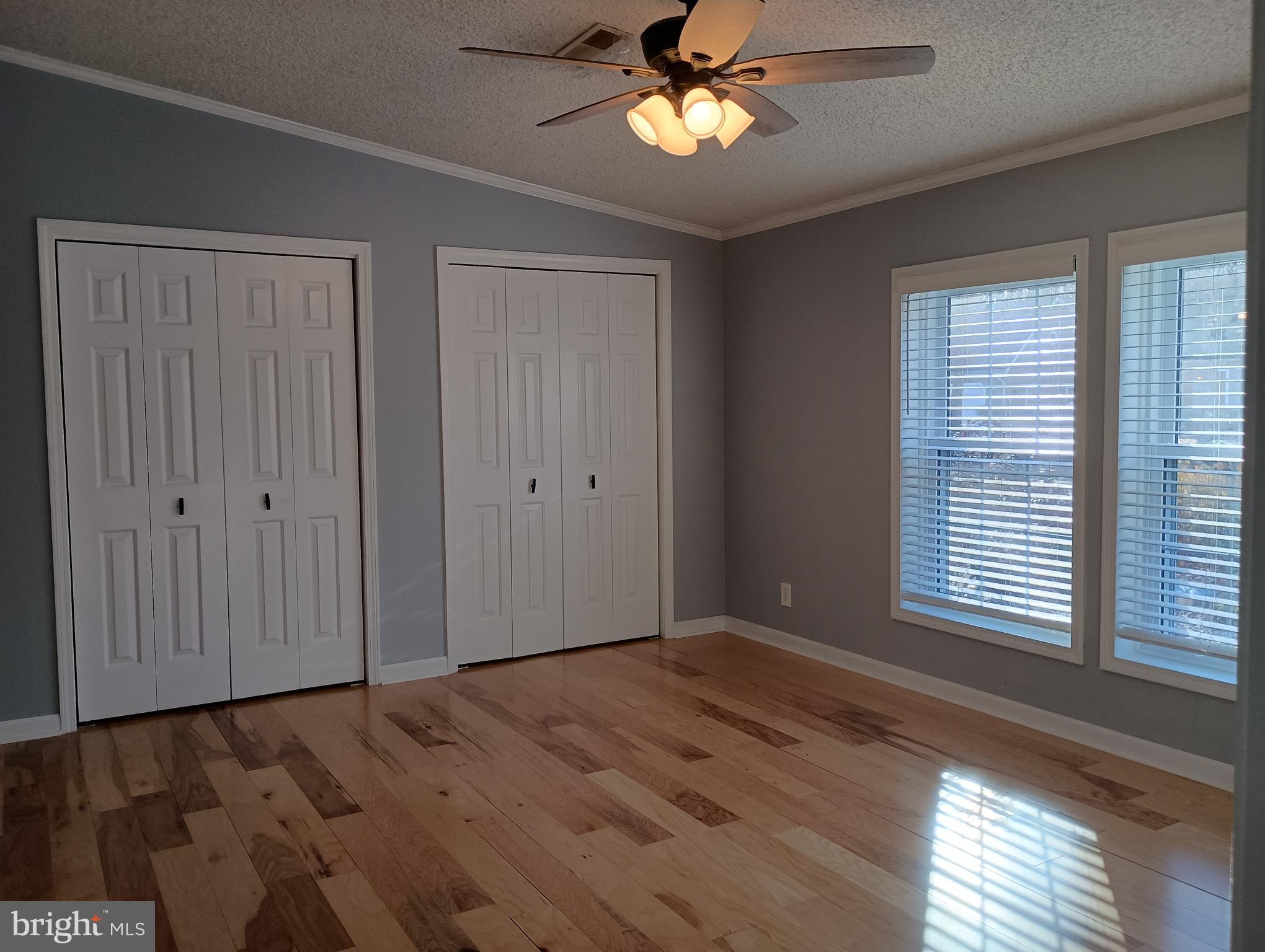 32217 Sandpiper Drive Lewes, DE 19958 - Photo 10 of 21 a view of an empty room with a window and wooden floor