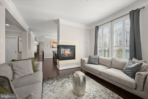 a living room with furniture fireplace and window