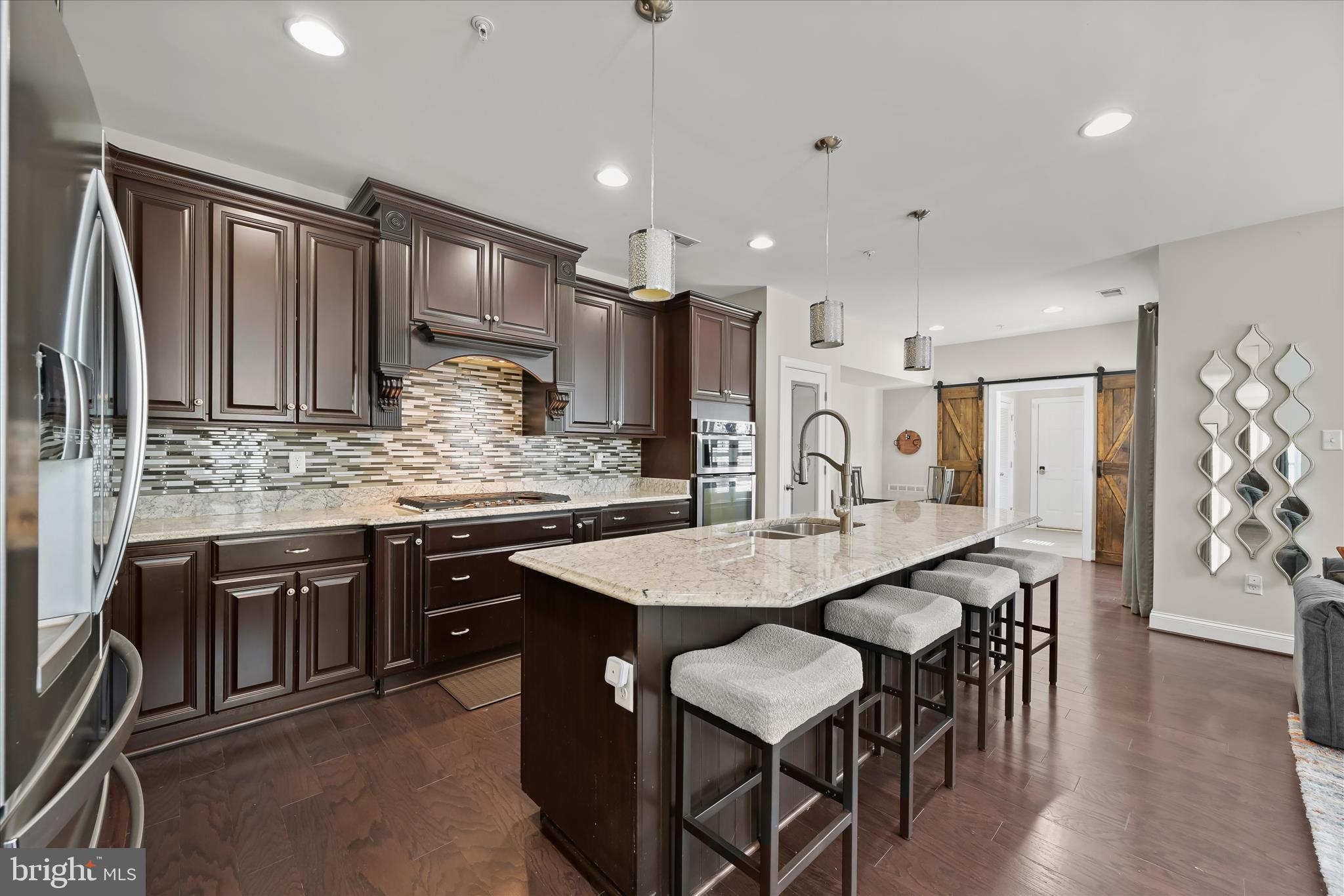 11295 Market Street Fulton, MD 20759 - Photo 21 of 62 a kitchen with stainless steel appliances kitchen island granite countertop a kitchen island hardwood floor and a sink