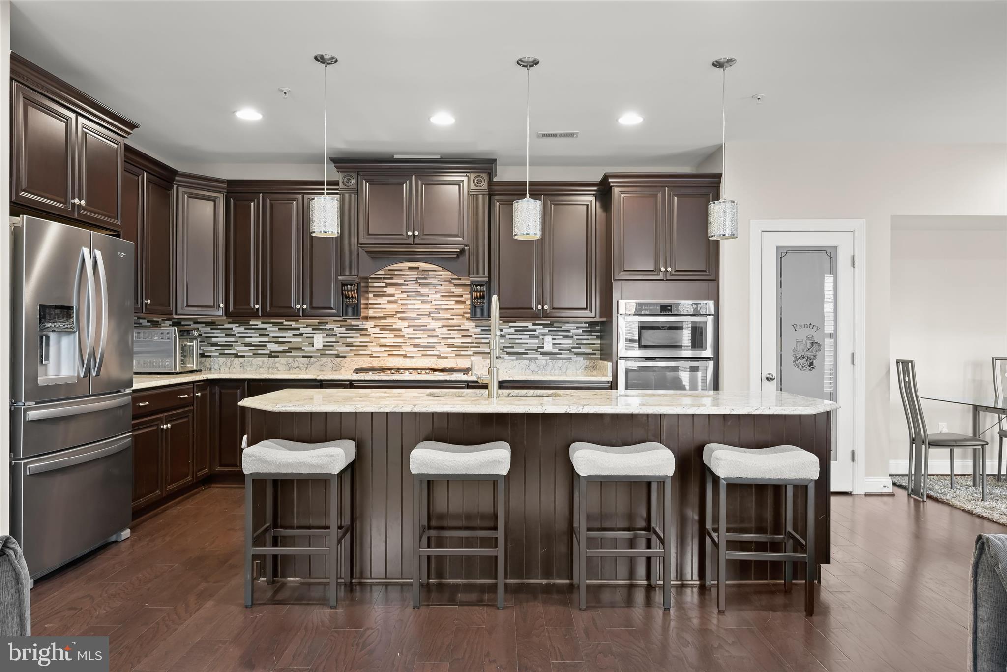 11295 Market Street Fulton, MD 20759 - Photo 22 of 62 a kitchen with stainless steel appliances granite countertop a table chairs sink refrigerator and microwave