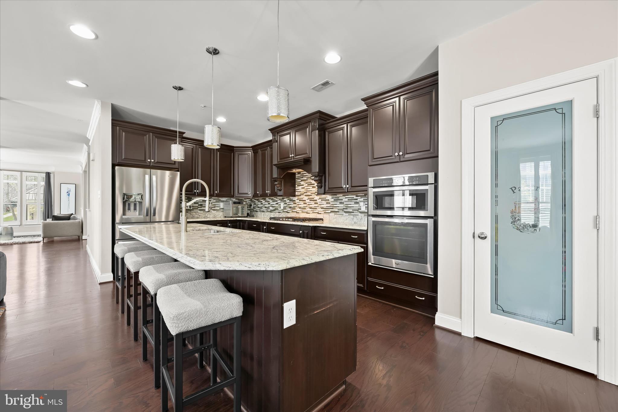 11295 Market Street Fulton, MD 20759 - Photo 23 of 62 a kitchen with stainless steel appliances granite countertop a refrigerator a stove a sink a dining table and chairs