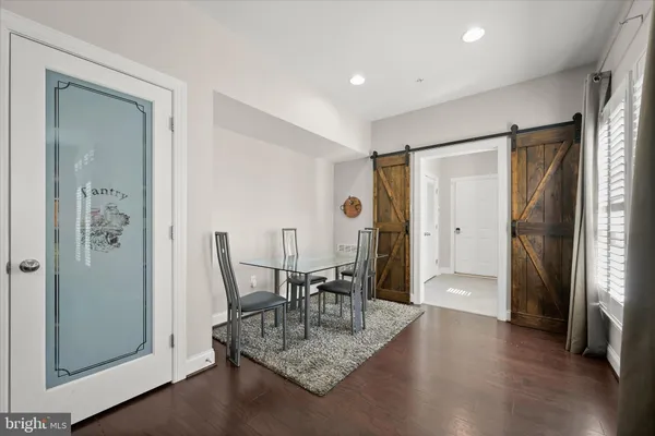 a bedroom with a large bed and wooden floor