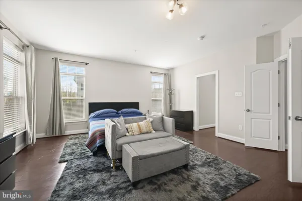 a bedroom with a large bed and a large window