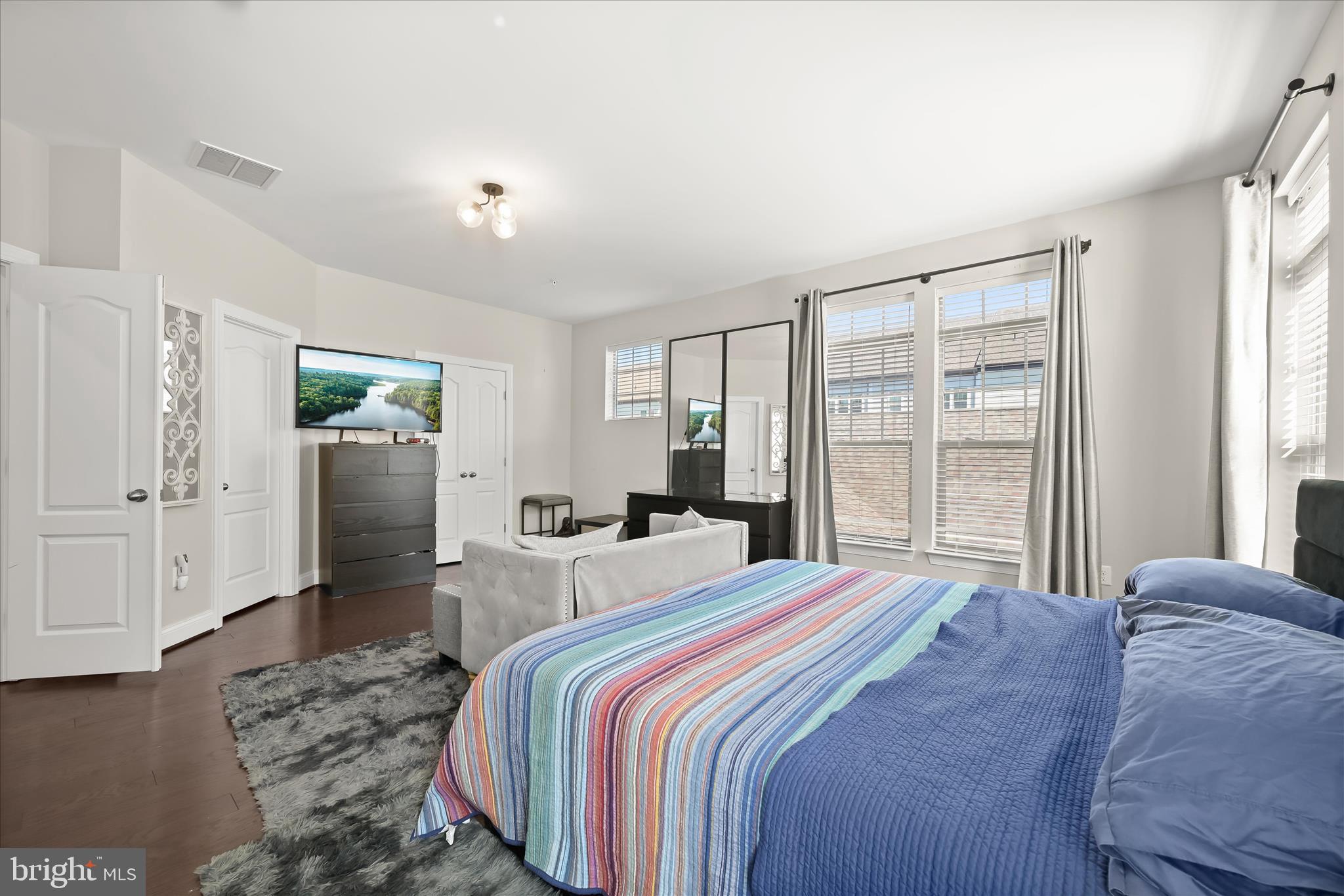 11295 Market Street Fulton, MD 20759 - Photo 32 of 62 a bedroom with a large bed and wooden floor