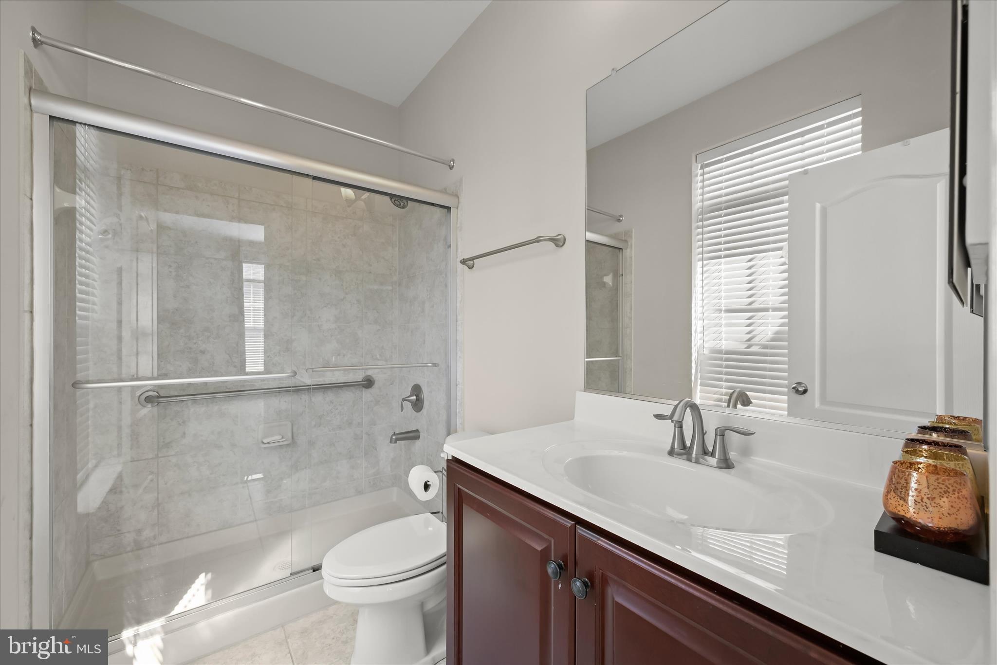 11295 Market Street Fulton, MD 20759 - Photo 39 of 62 a bathroom with a sink a toilet and a large mirror