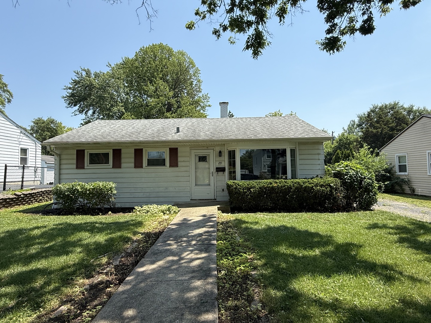 29 Roslyn Road Westmont, IL 60559 - Photo 2 of 11 a front view of a house with a garden