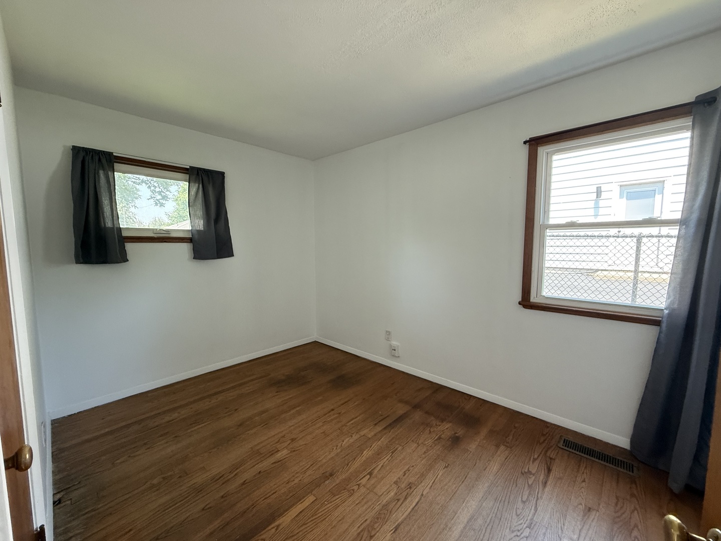 29 Roslyn Road Westmont, IL 60559 - Photo 7 of 11 an empty room with wooden floor and windows