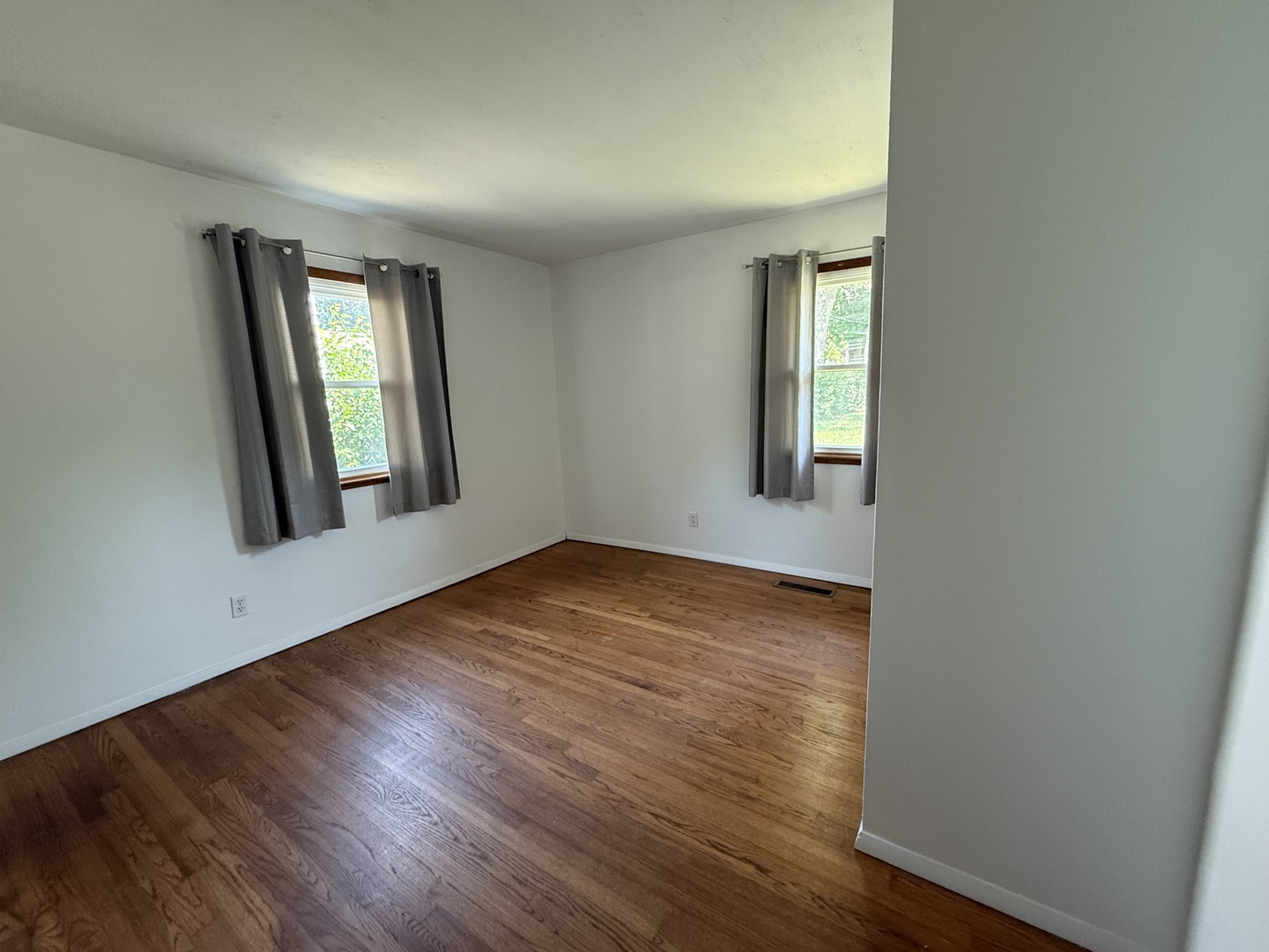29 Roslyn Road Westmont, IL 60559 - Photo 8 of 11 an empty room with wooden floor and windows