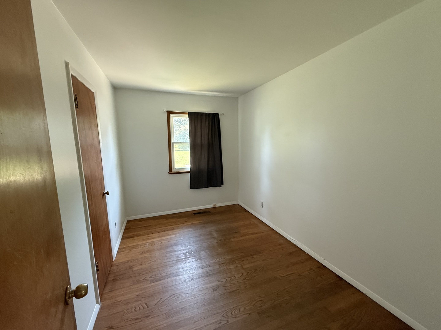29 Roslyn Road Westmont, IL 60559 - Photo 9 of 11 an empty room with wooden floor and windows