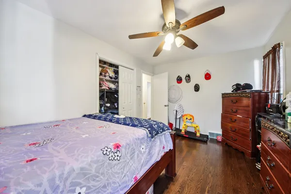 a bedroom with a bed dresser and a window