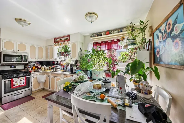 a kitchen with sink refrigerator and cabinets