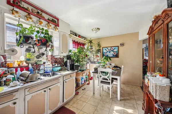 a group of people sitting in a kitchen