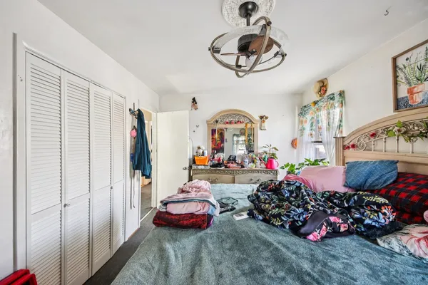 a bedroom with furniture and a chandelier