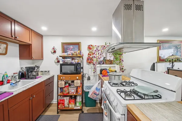 a kitchen with stainless steel appliances a stove a sink and a refrigerator