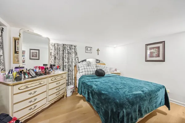 a bedroom with a bed and a dresser