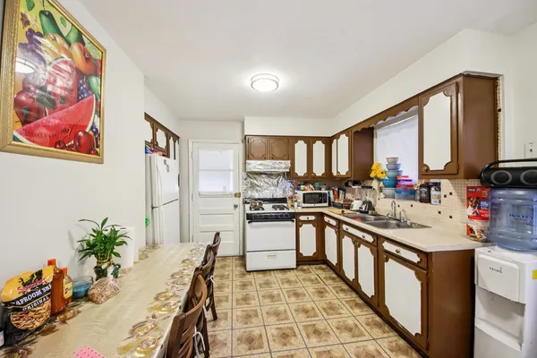 a kitchen with a sink stove and cabinets
