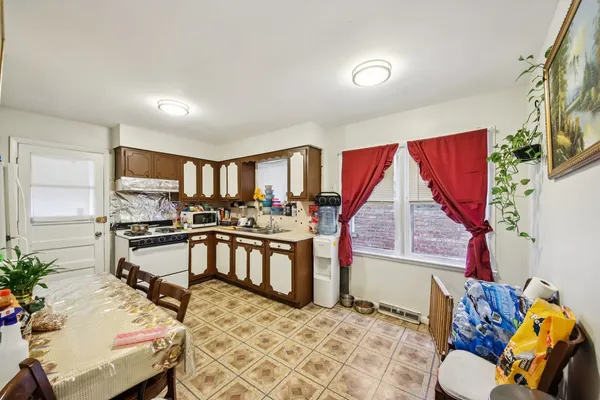 a living room with furniture a flat screen tv and a large window