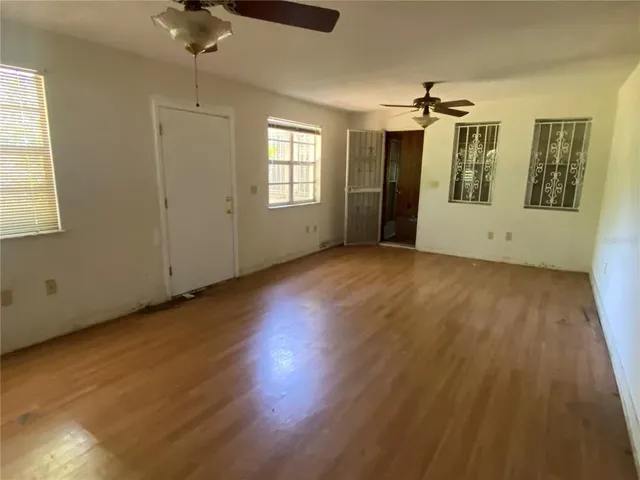 wooden floor in an empty room with a window
