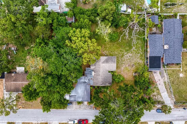 an aerial view of a house with a yard and garden
