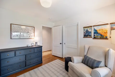a living room with furniture and a open kitchen view