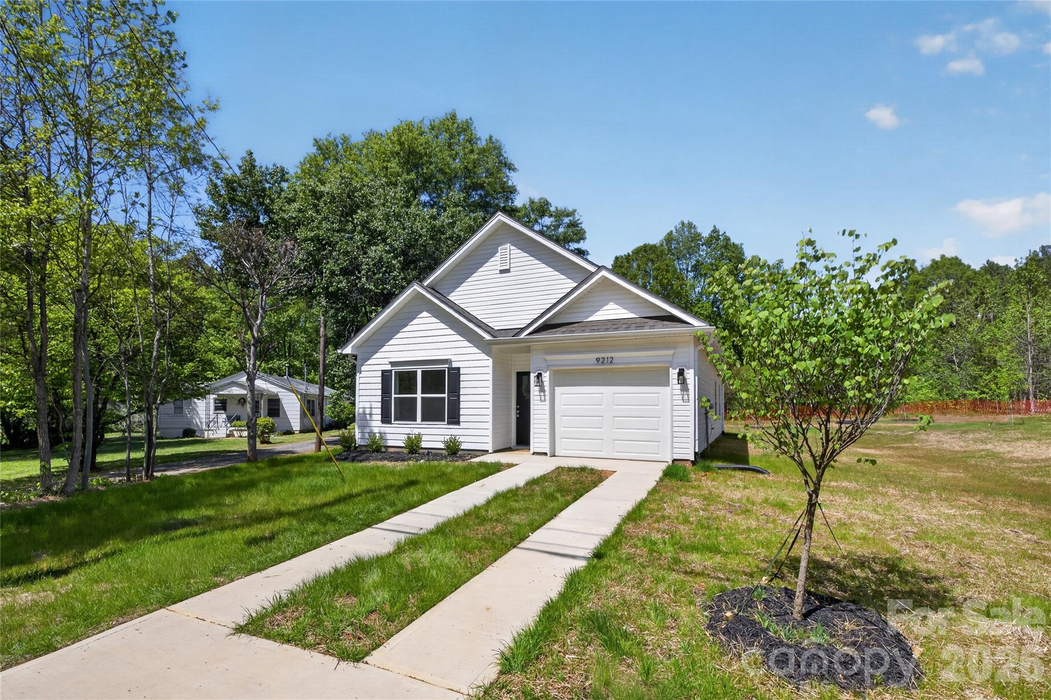9212 Moores Chapel Road Charlotte, NC 28214 - Photo 2 of 23 a front view of a house with a yard