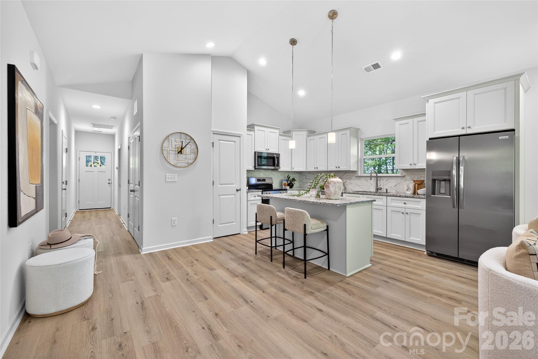 9212 Moores Chapel Road Charlotte, NC 28214 - Photo 4 of 23 a kitchen with a refrigerator a sink and a stove top oven