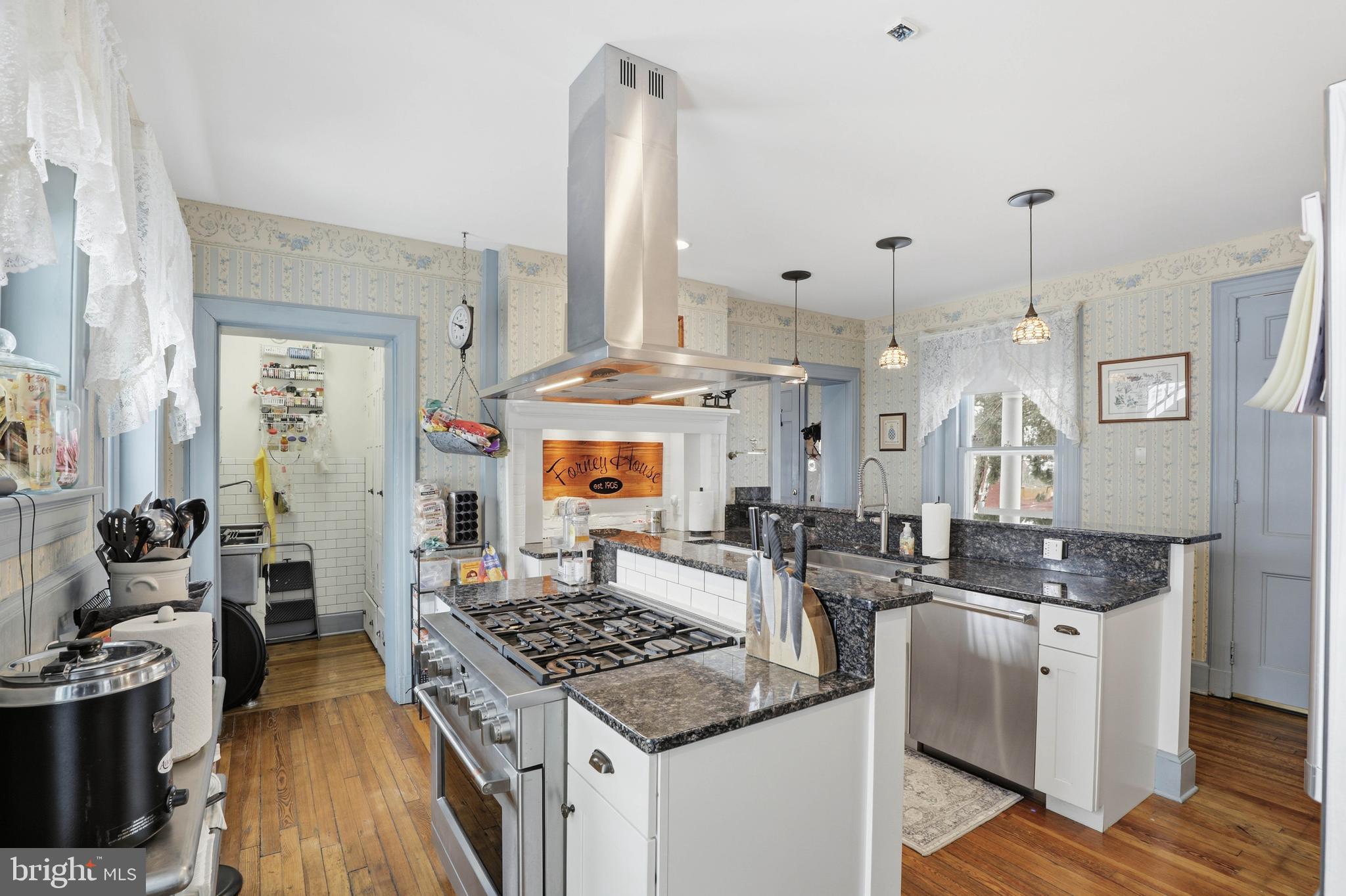 252 Frederick Street Hanover, PA 17331 - Photo 25 of 107 a kitchen with stainless steel appliances granite countertop a stove a sink dishwasher and white cabinets with wooden floor