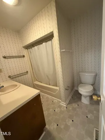 an empty room with chandelier fan