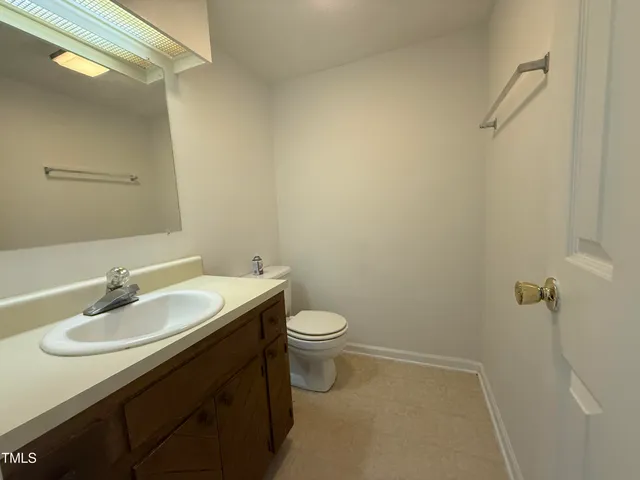 a bathroom with a sink toilet and a mirror