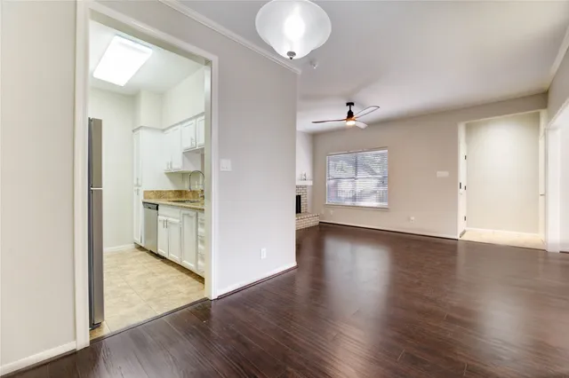 a view of a kitchen with wooden floor and a window