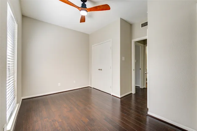 a view of a room with wooden floor