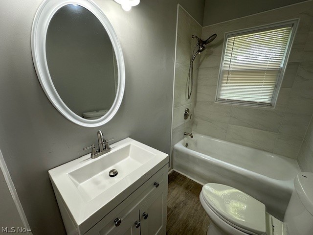 1388 Brookline Road Cleveland, OH 44121 - Photo 18 of 30 Full bathroom featuring hardwood / wood-style flooring, tiled shower / bath, vanity, and toilet