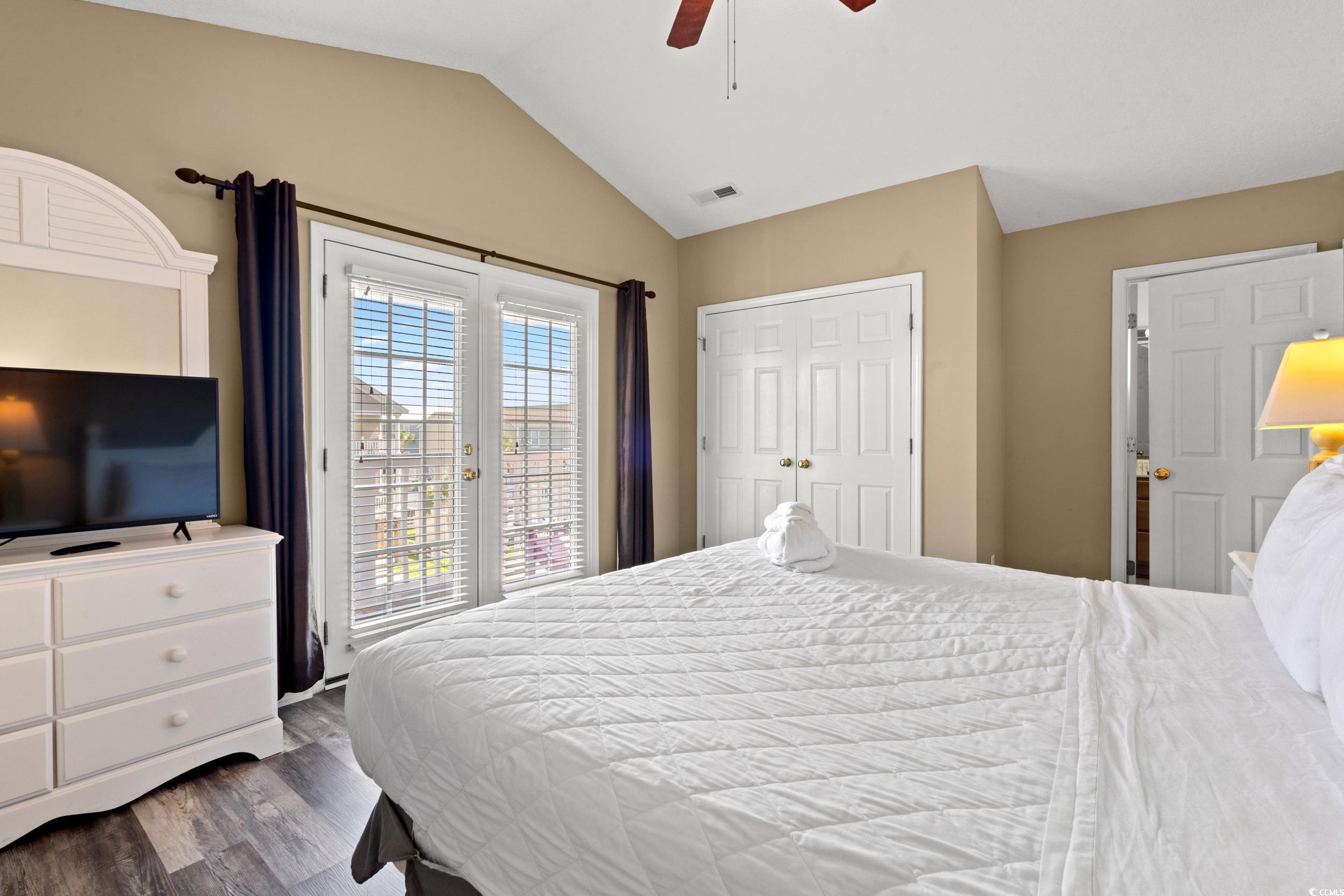 113 B 15th Avenue South Surfside Beach, SC 29575 - Photo 15 of 40 Bedroom featuring access to exterior, vaulted ceiling, dark wood-style floors, ceiling fan, and a closet
