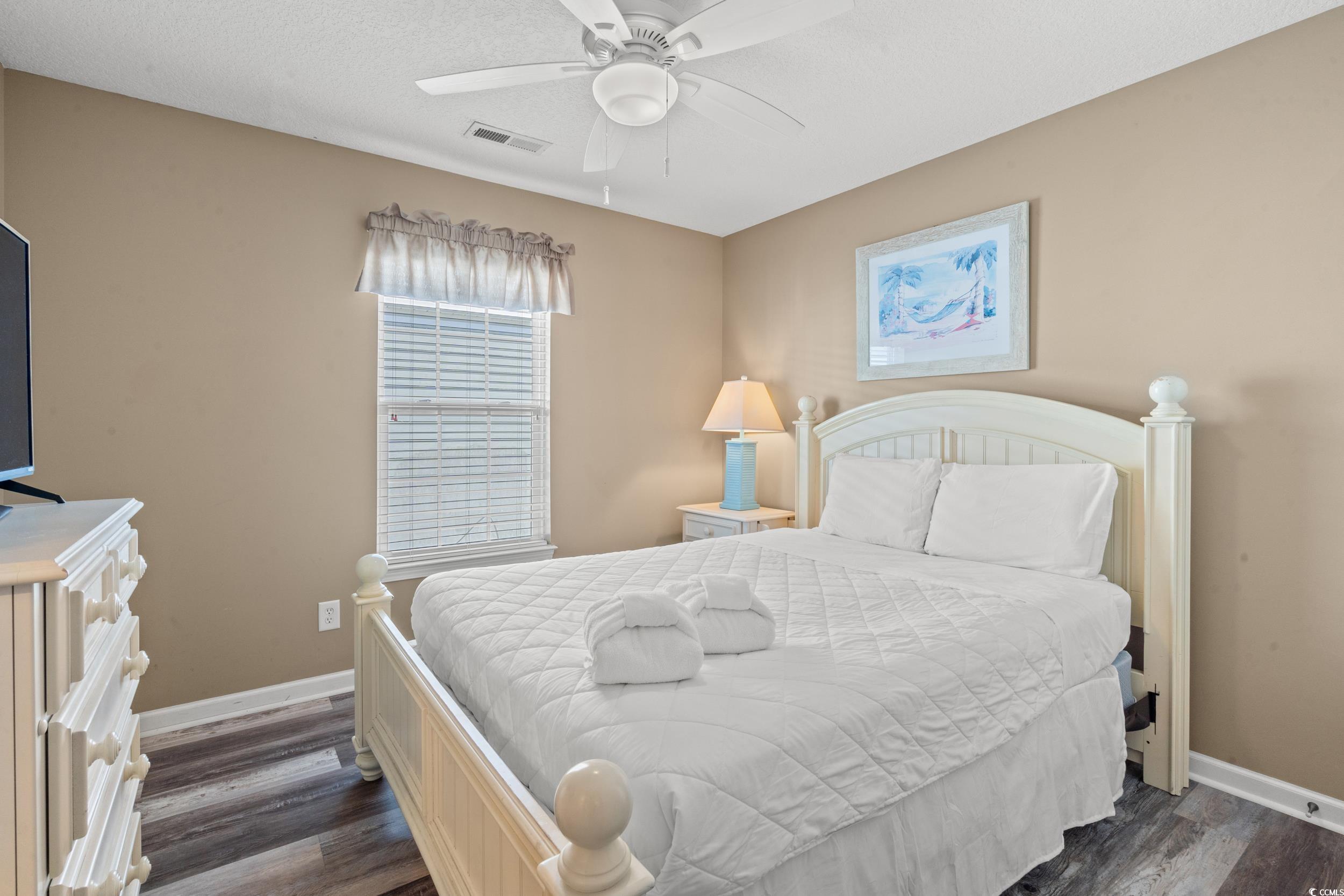 113 B 15th Avenue South Surfside Beach, SC 29575 - Photo 19 of 40 Bedroom with dark wood-style floors, a ceiling fan, and a textured ceiling