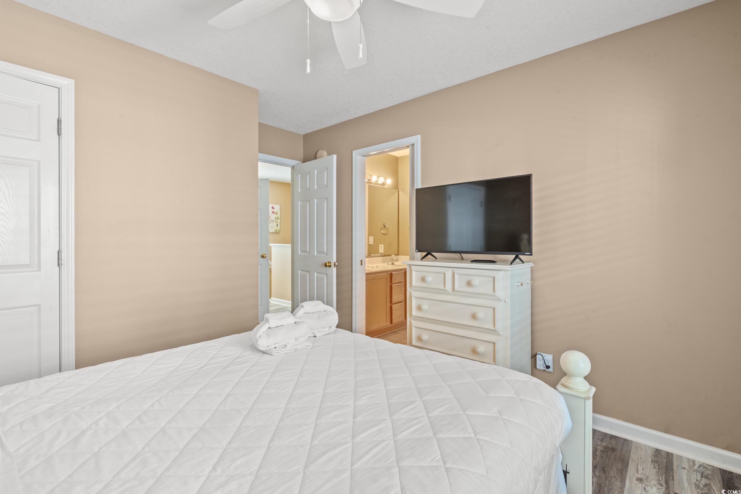 113 B 15th Avenue South Surfside Beach, SC 29575 - Photo 21 of 40 Bedroom featuring light wood finished floors, a ceiling fan, and ensuite bath
