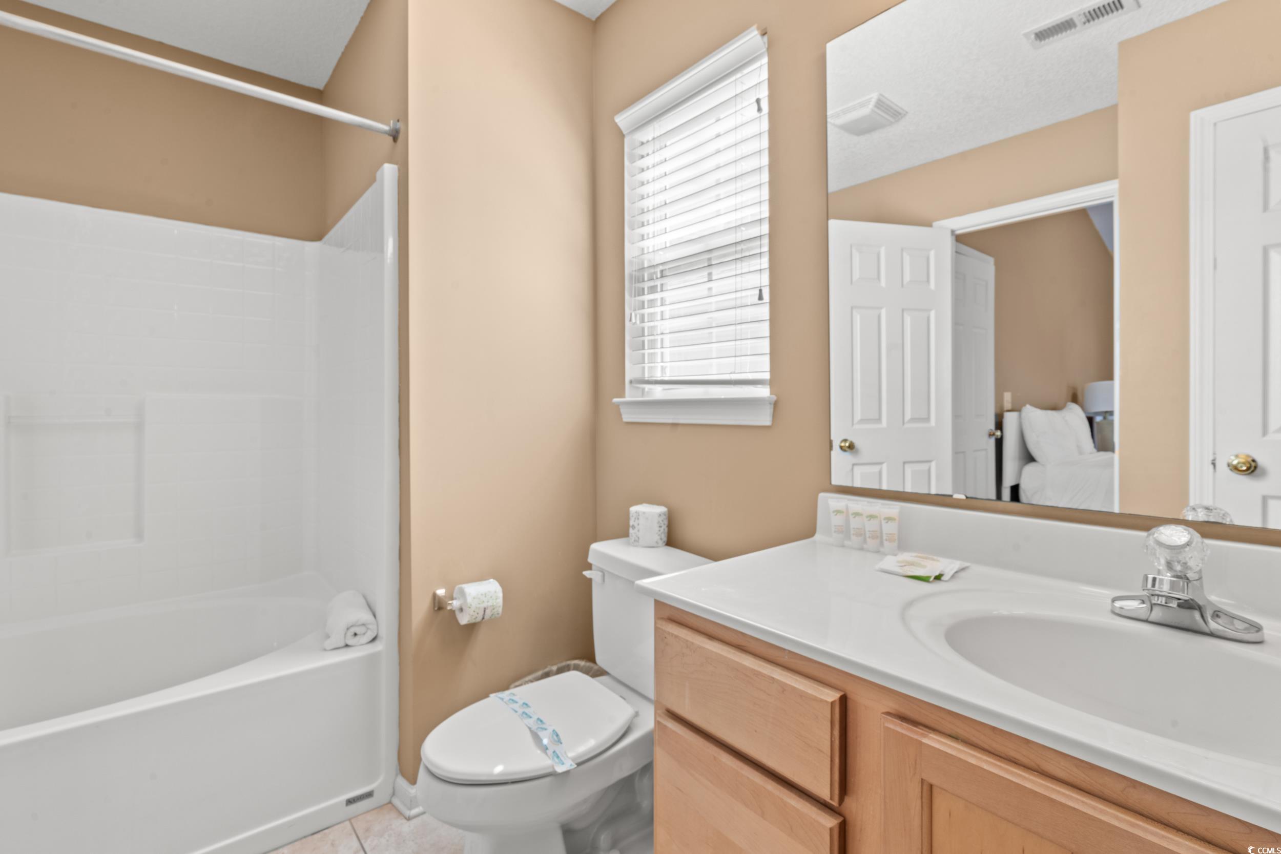 113 B 15th Avenue South Surfside Beach, SC 29575 - Photo 28 of 40 Bathroom featuring light tile patterned floors, vanity, and washtub / shower combination