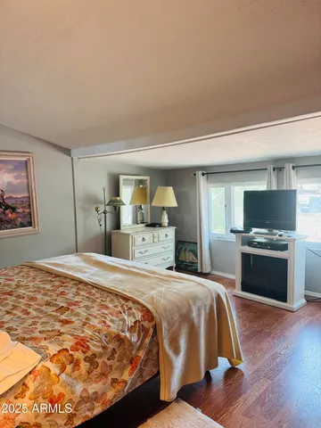 a bedroom with a large bed and a television