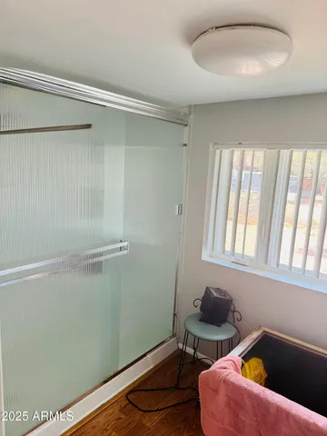 a bathroom with a window and a shower