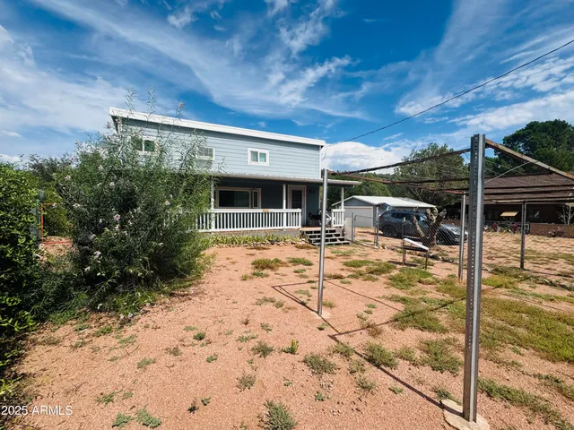 a view of a house with backyard porch and sitting area