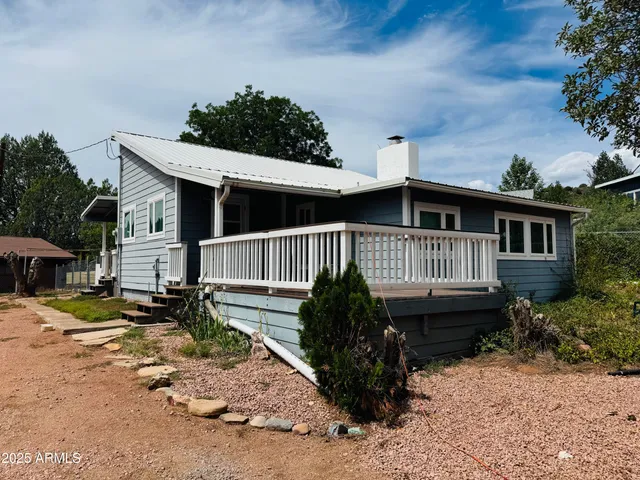 a view of a house with wooden floor roof and sitting area