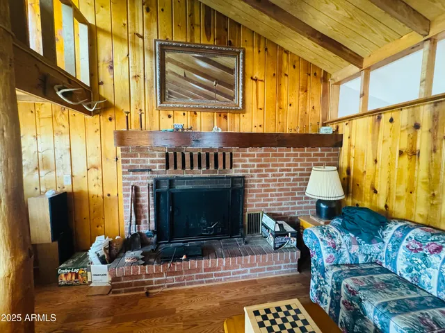 a living room with furniture a fireplace and a window