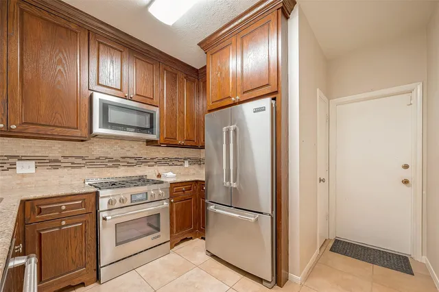 a kitchen with a refrigerator stove and sink