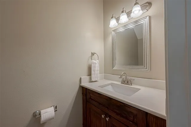 a bathroom with a sink vanity and a mirror