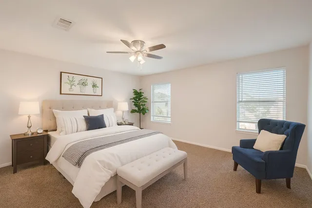 a spacious bedroom with a bed and a couch